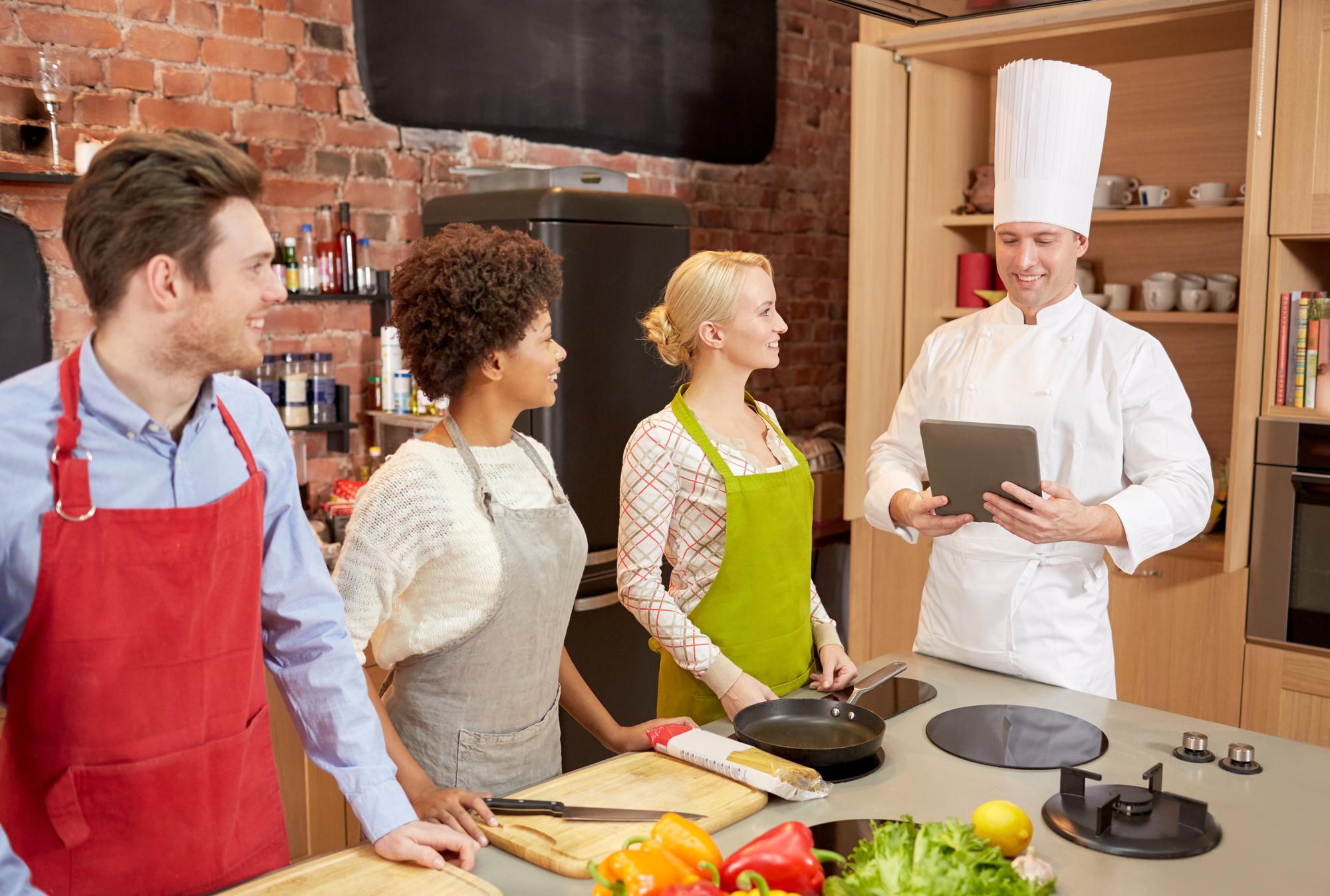 Instructor speaking to small cohort in kitchen